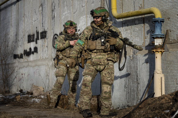 Ukrainian servicemen of Rapid Operational Response Unit patrol a street in Bakhmut on Friday.