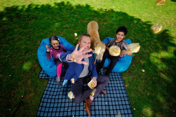 Moonee Valley mayor Cam Nation with Ari and Hazel Nair, aged nine and five, respectively, at Queens Park where a pop-up cinema could open once the road map allows.