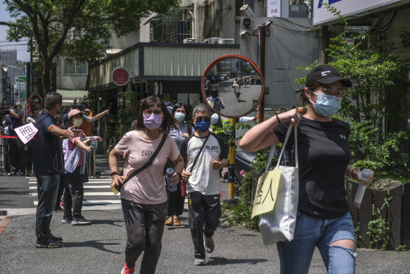 Residents run to a shelter during an air raid drill in Taipei, Taiwan, in July 2022.