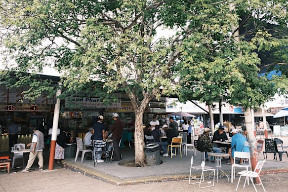The square at Inala Plaza where people eat, gather and play Chinese chess.
