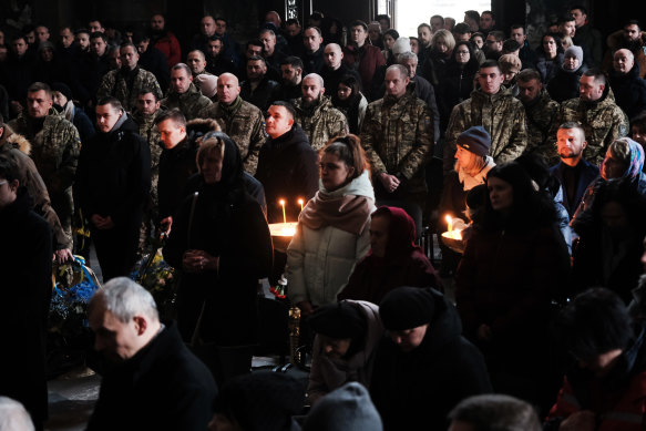 Civilians, family and members of the military attend the funeral of soldier Grygory Dobosh, who was killed in a battle in Snihurivka on December 29, in Lviv, Ukraine.