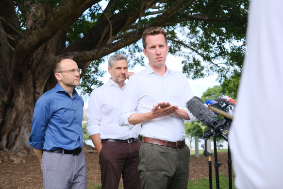Federal Greens leader Adam Bandt, state MP for Maiwar, Michael Berkman, and federal MP for Griffith, Max Chandler-Mather, at a press conference in New Farm park.
