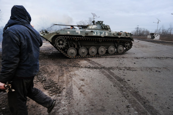 A Ukrainian tank is off loaded along a road outside of the strategic city of Bakhmut.