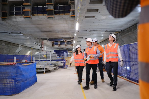 Deputy Premier Cameron Dick, State Development Minister Grace Grace and Transport Minister Bart Mellish tour the Albert Street station’s now-constructed platform and mezzanine level above.