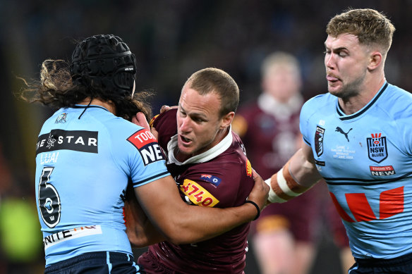 NSW’s Jarome Luai tackles Queensland’s Daly Cherry-Evans.