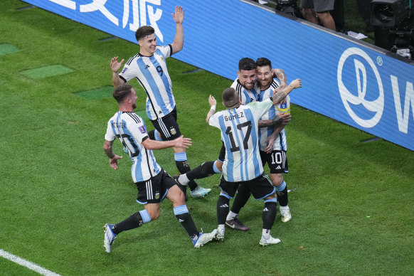 Argentina’s Lionel Messi, right, celebrates with teammates after scoring the opening goal.