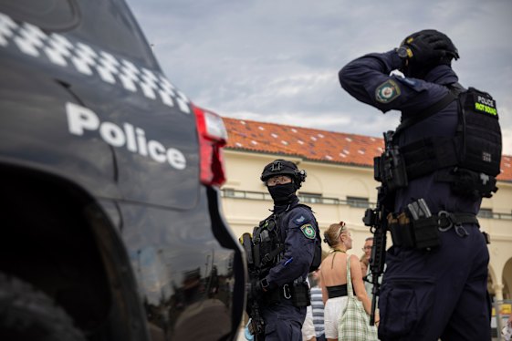 Members of the NSW Police riot squad keep watch over Bondi Beach.