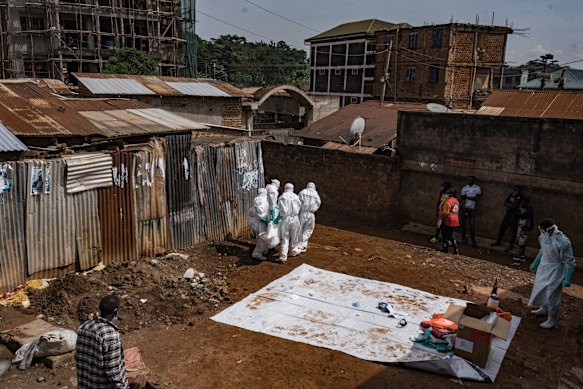 Workers from the Uganda Red Cross Society evacuate the body of a suspected Ebola victim in Kampala on May 26.