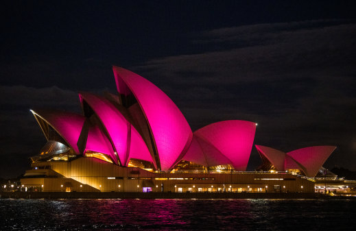 The sails of the Sydney Opera House glowing pink to honour the life of Dame Olivia Newton-John.