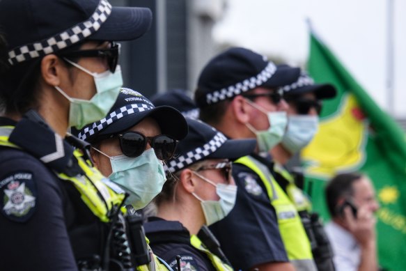 Police guarding the office of Greg Hunt during the rally