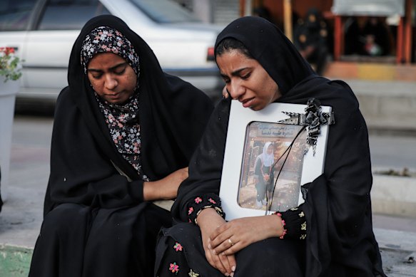 In this picture obtained from Iran’s ISNA news agency, mourners attend the funeral of children killed in a reported strike on the primary school.