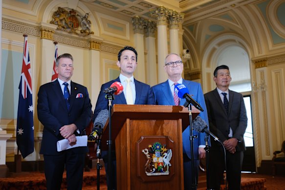 Deputy Premier Jarrod Bleijie and Premier David Crisafulli with Thomas Bradley and his partner, Dr Matthew Yoong.