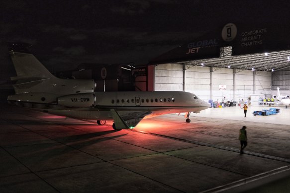 Warne’s plane taxis into the hangar.