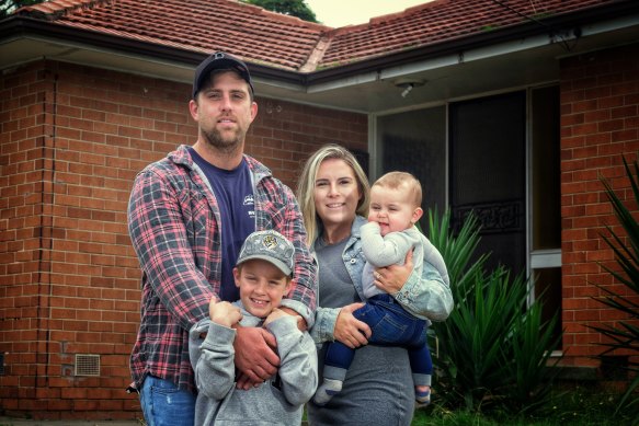 James Dalglish and partner Kimberly Mattuchio with children Carter and Archi in front of their newly purchased home.