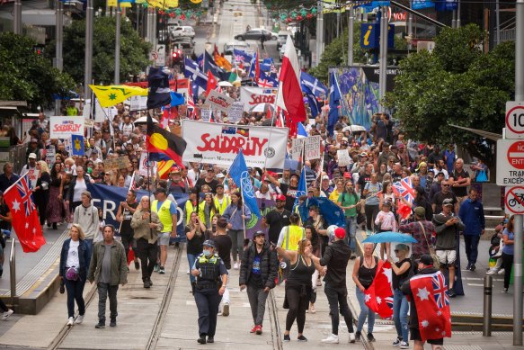 Angry protesters marching through Melbourne’s CBD in late 2021. 