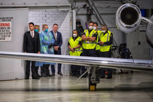 Officials greet the plane on arrival.