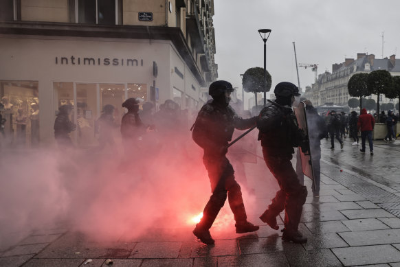 Riot police scuffle with protesters during a protest in Rennes.