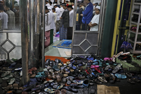 Footwear is left outside a mosque in Jakarta during evening prayers for the start of Ramadan.