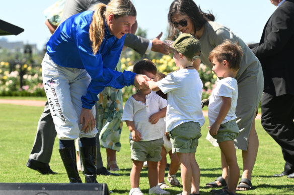 Kah is presented the Dean Holland Trophy by his children.