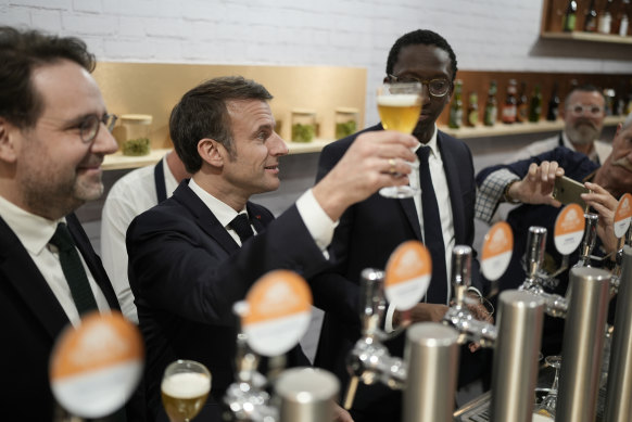 Expect to pay more if you want to raise a glass, like French President Emmanuel Macron (pictured, centre),  in Paris this European summer.