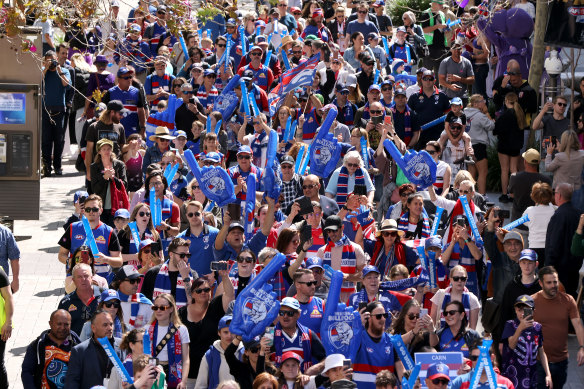 Bulldogs supporters march down the street during the People’s Parade in Perth CBD ahead of the 2021 AFL grand final.