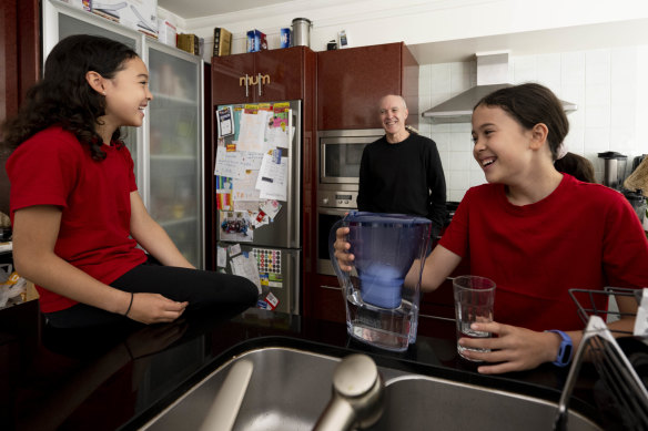 Nick Enfield with his daughters, Nonnika, 8, and Nyssa, 10, in their Sydney home. He is part of a group of researchers that have found that people are seven times more likely to say yes than no to family and friends’ requests.