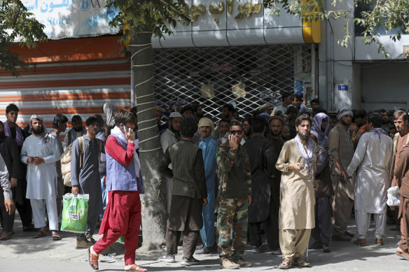 Afghans waited for hours to withdraw money as the Taliban advanced on Sunday.  