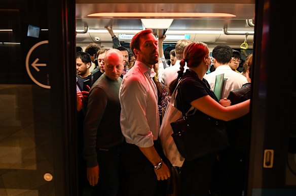 Passengers squeeze on a metro train at Crows Nest station during the morning peak.