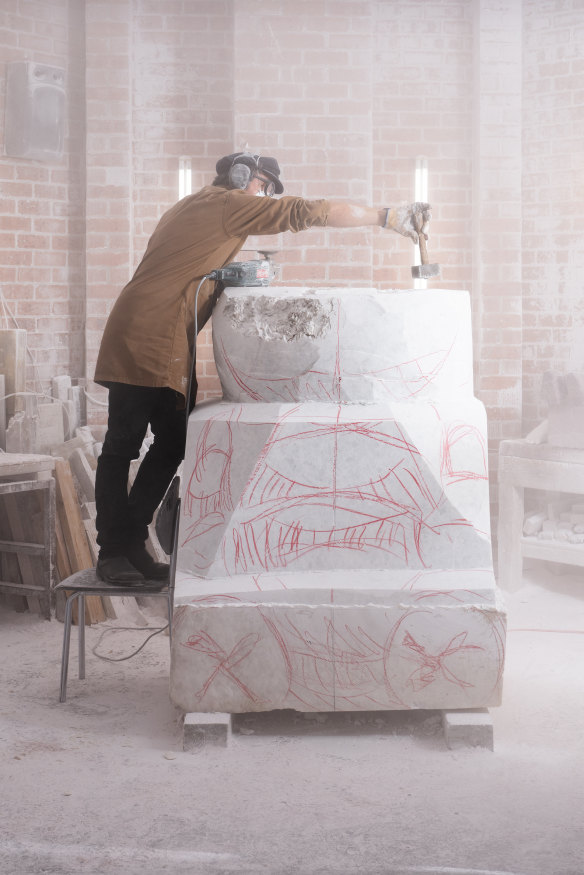 Seton in the process of carving the giant puffer-jacket sculpture.