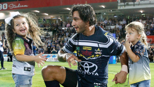 Man of the moment: Johnathan Thurston enters the field for his 271st game for the Cowboys with his daughters Frankie (left) and Charlie.