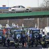 ‘Angry’ French farmers’ tractor siege shuts down highways to Paris