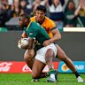 South Africa’s Aphelele Fassi, front, is challenged by Australia’s Joseph-Aukuso Suaalii.