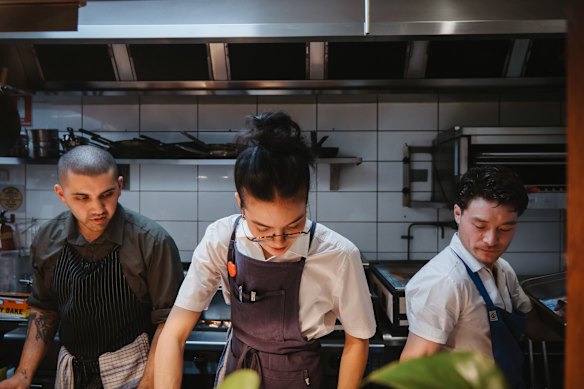 Chef Laura Koentjoro Harding (centre) in the Banksia Tavern kitchen with Rohan Todd (left) and Liam Monaghan (right).