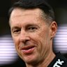 Craig McRae, the senior coach of the Magpies, looks on.
