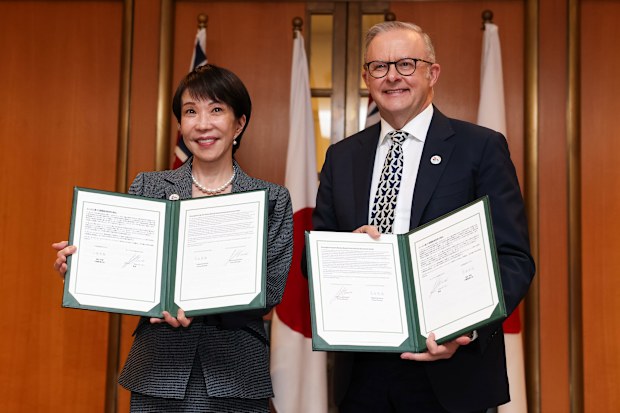 Anthony Albanese, right, with Japanese Prime Minister Sanae Takaichi after signing a joint agreement in Canberra.