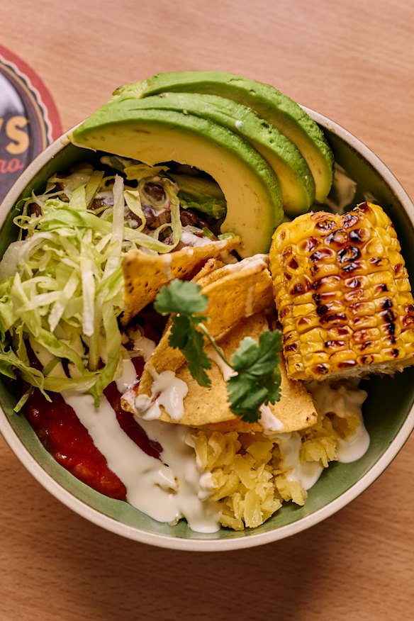 A Mexican food truck dishes up tacos and nachos.