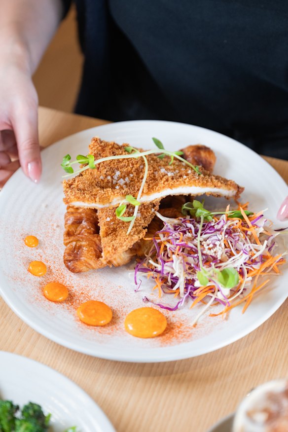 Waffled croissant with fried chicken.