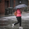 A woman fights the wind and rain in South Yarra earlier this year. 