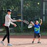 Nate Chen, 6, tries out his serve at Mitcham Tennis Club.