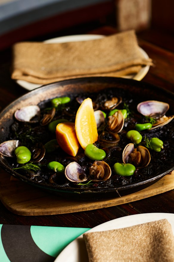 Bomba arroz negro (black rice seafood paella).
