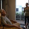 Dirk Skelton inside his accommodation, talks with Trish Bowie.