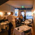 Peek inside Bistra to find white-clothed tables and whitewashed walls.