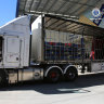 Police raid a storage unit at Cromer on Monday, where they arrested a truck driver