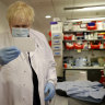 Britain's Prime Minister, Boris Johnson pictured during a visit to a vaccine lab in Oxford, has announced heavy new fines for COVID rule-breakers. 