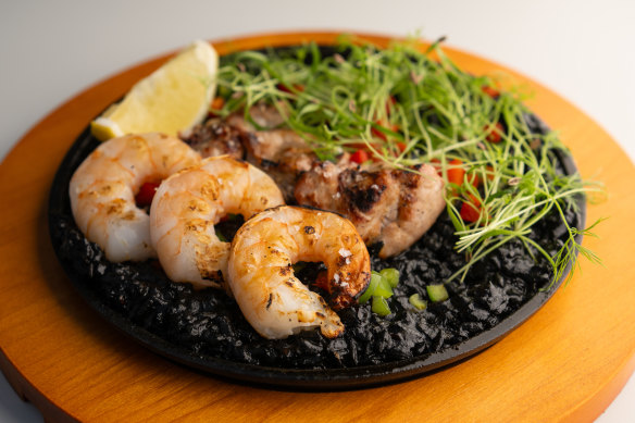 Sweetbread and prawn paella, the rice turned pitch-black with squid ink. 