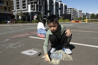Juliana Lee's son Ashton, 7, plays in a parking lot in Wentworth Point with his cousin.