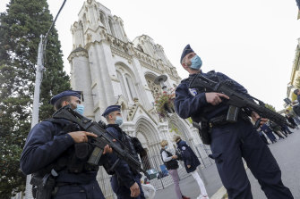 Police officers stand guard near Notre-Dame Basilica in Nice following the fatal attack.