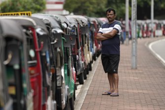 Bir otomatik çekçek sürücüsü, Colombo'da yakıt bulmayı umarak kuyrukta bekler.