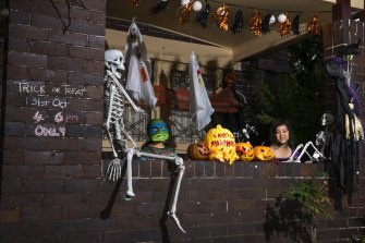 Mila Salakas and Brandon Salakas with their grandparents’ Halloween decorations which includes a witch on a zip-line to deliver treats to the front gate in a covid safe way