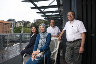Raneem Emad and Roaa Ahmed, who topped Arabic, with their fathers 